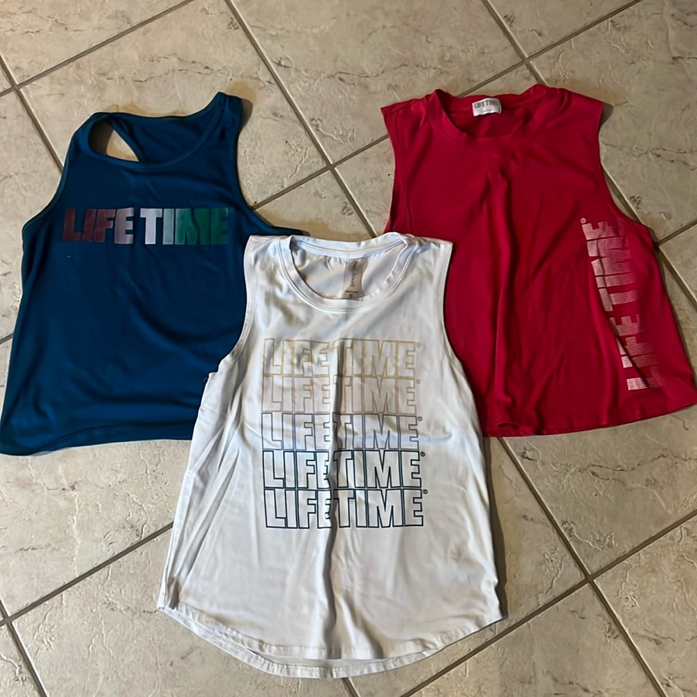 Set of three Lifetime Fitness workout tops in teal hot pink and white